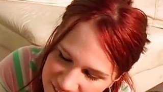 Clothed redhead gives handjob